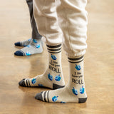 Beige socks with text and blue dreidel design worn by a person on a wooden floor. thumbnail