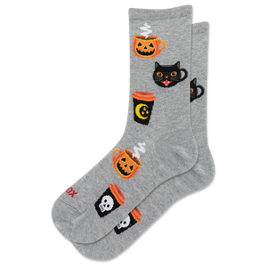 A pair of heather gray crew socks with a Halloween pattern featuring jack-o'-lanterns, black cats, and coffee cups, shown on a plain white background.