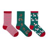 Three pairs of Christmas-themed crew socks displayed side-by-side on a plain white background. The left pair features red and white horizontal stripes with a red toe and heel.