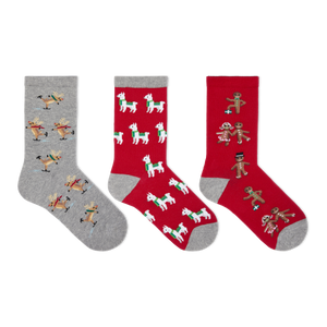 Three Christmas-themed crew socks displayed side-by-side on a plain white background. The left sock is heather gray with a pattern of skating reindeer.