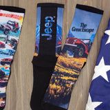 Set of socks with Jeep-themed designs on a wooden surface