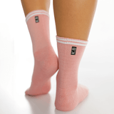 Pink socks with white stripes and a logo on a white background