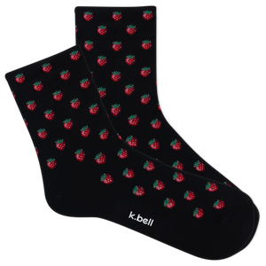Black socks with red strawberry pattern and 'k.bell' branding on a white background