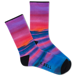 Two people wearing matching outfits with colorful socks in a casual setting.