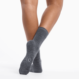 Gray socks worn by a person on a white background