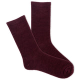 A pair of women's velvet crew socks in a deep maroon color.