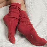Red socks with a k.bell brand logo on a white textured surface