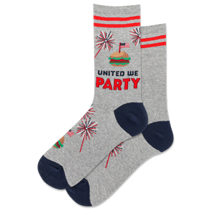 A pair of women's crew socks with a patriotic red, white, and blue design featuring text 'UNITED WE PARTY' and fireworks graphics.